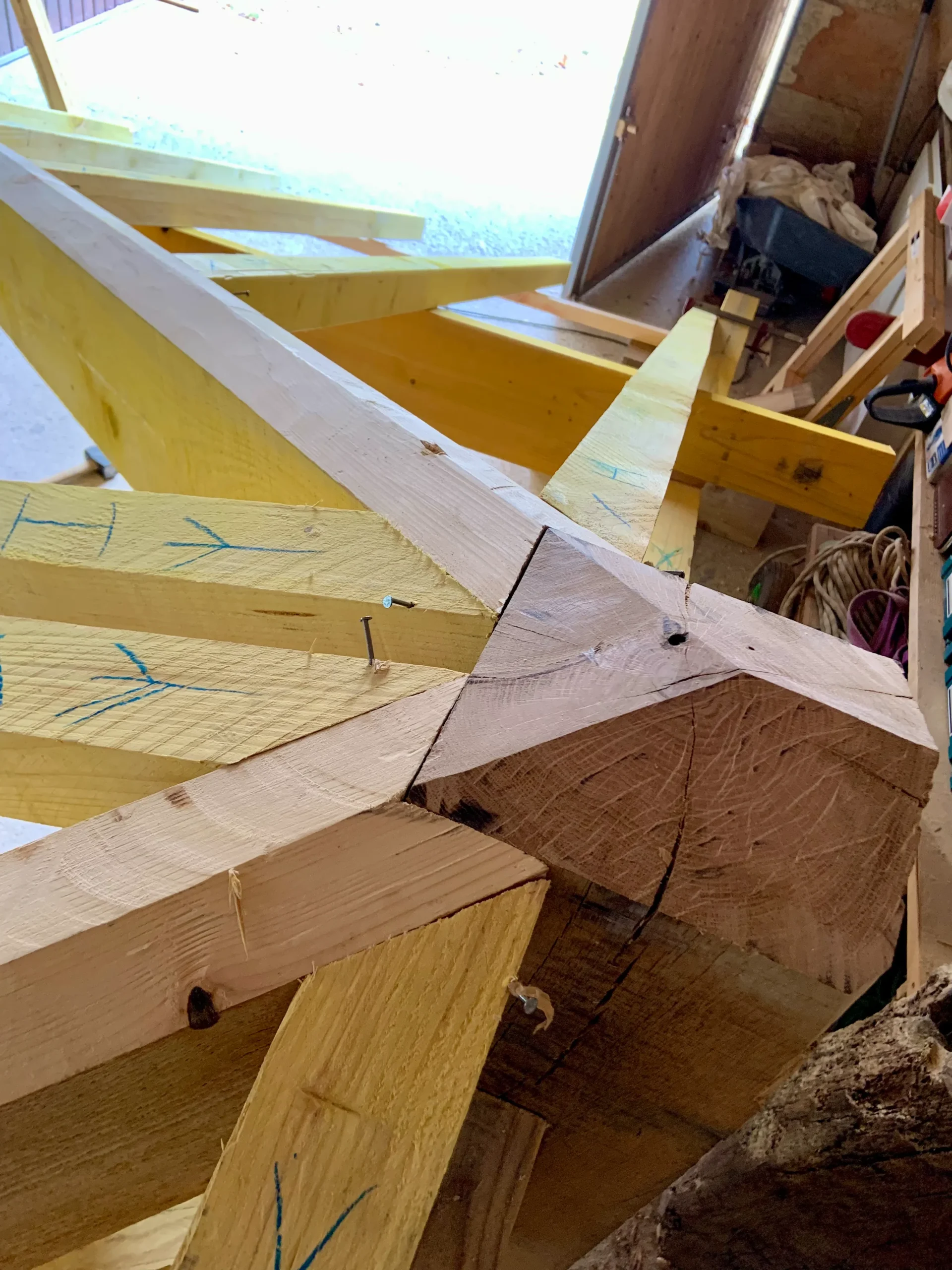 Gros plan des assemblages de charpente autour de la tête de poinçon, préparés en atelier pour Anglade